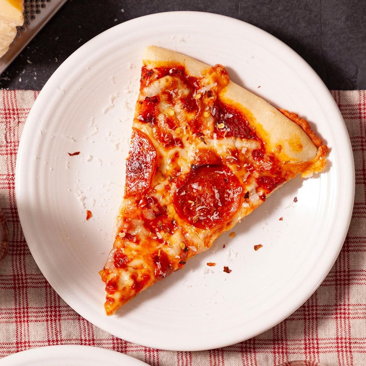 A slice of pepperoni pizza served on a plate.